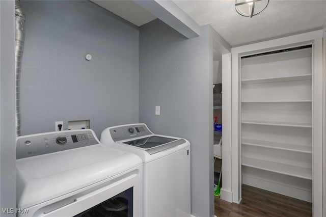 washroom featuring separate washer and dryer and dark wood-type flooring