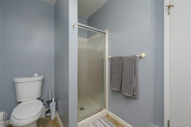 bathroom with an enclosed shower and toilet