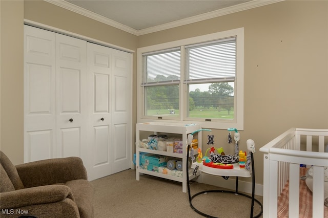 bedroom featuring crown molding, a closet, carpet, and a crib