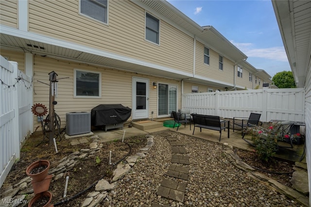 back of house with outdoor lounge area, a patio, and central AC unit