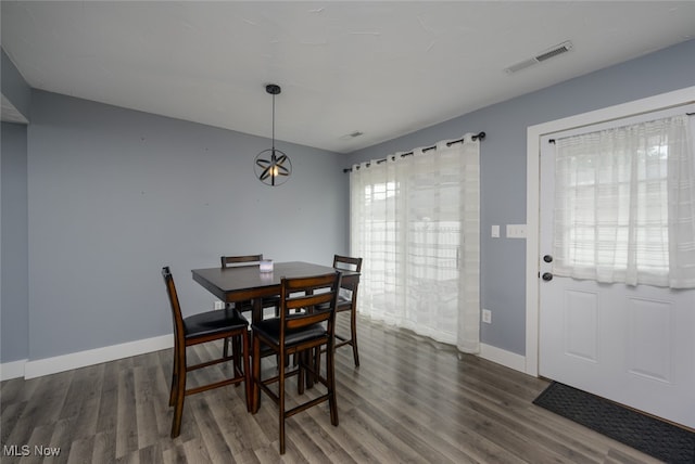 dining area with dark hardwood / wood-style flooring and a healthy amount of sunlight