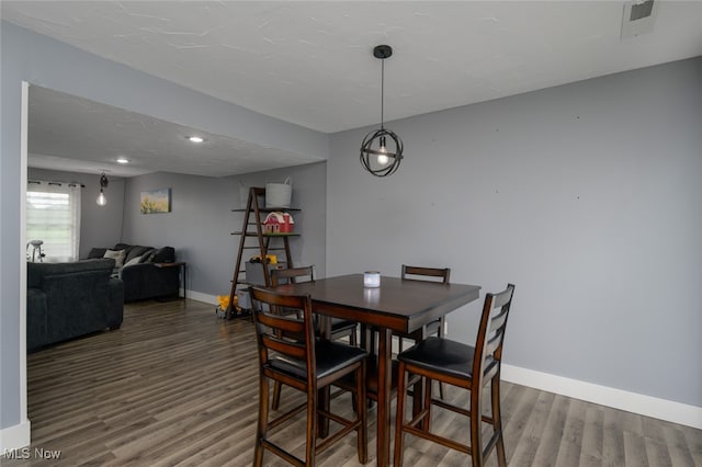 dining area with dark hardwood / wood-style floors