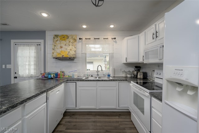 kitchen featuring decorative backsplash, dark hardwood / wood-style flooring, white appliances, sink, and white cabinets