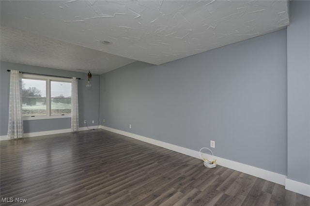 unfurnished room with dark hardwood / wood-style floors