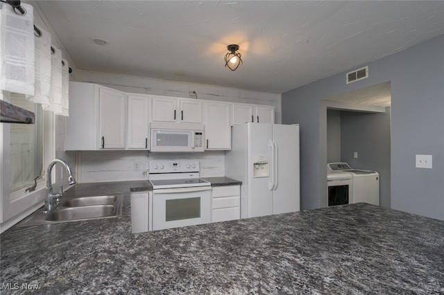 kitchen with separate washer and dryer, white cabinetry, sink, and white appliances