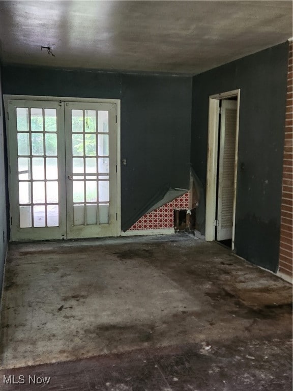 unfurnished room featuring french doors