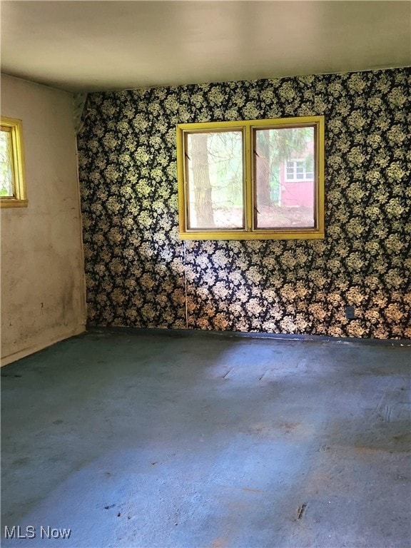 unfurnished room with concrete floors