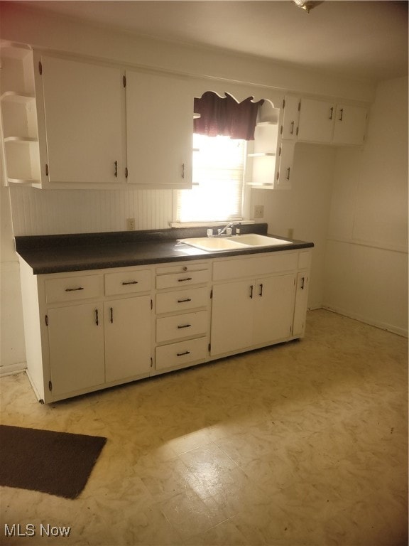 kitchen featuring white cabinetry and sink