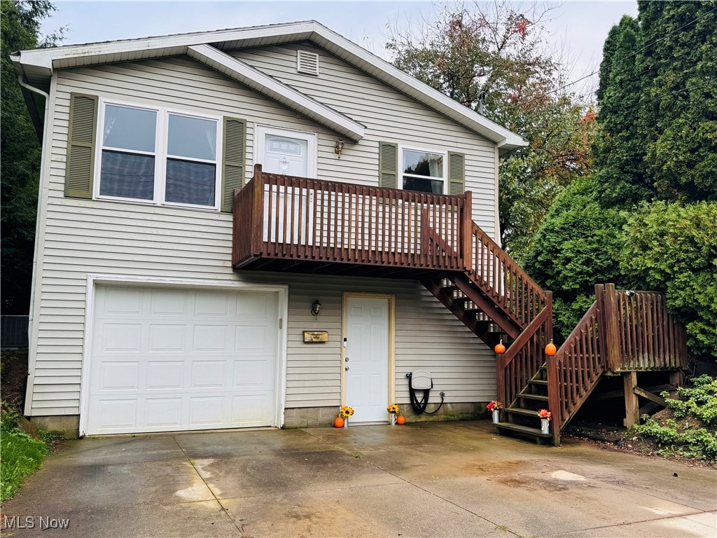 view of front of house featuring a garage and a wooden deck