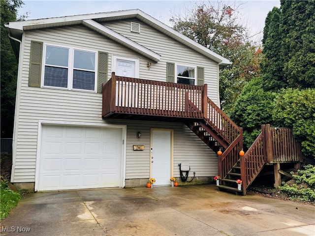 view of front of house featuring a garage and a wooden deck