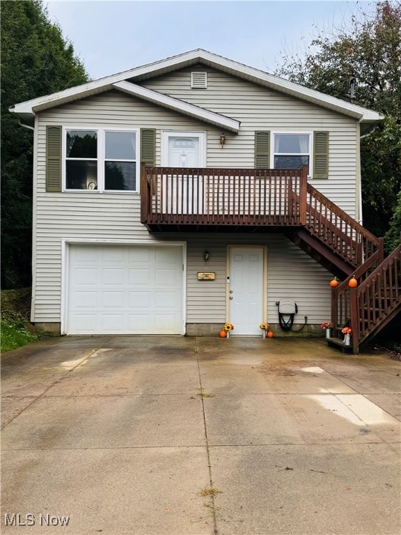 view of front of property featuring a garage and a wooden deck