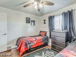 bedroom with ceiling fan and dark wood-type flooring