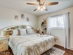 bedroom featuring ceiling fan and dark hardwood / wood-style floors