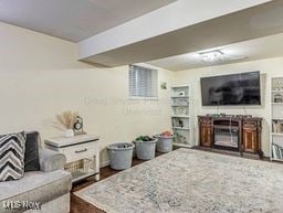 living room featuring a fireplace and dark hardwood / wood-style floors