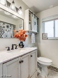 bathroom featuring vanity and toilet