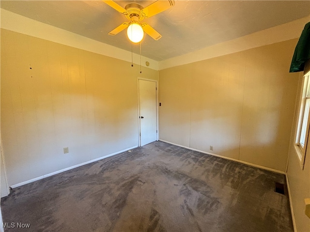 carpeted spare room with ceiling fan