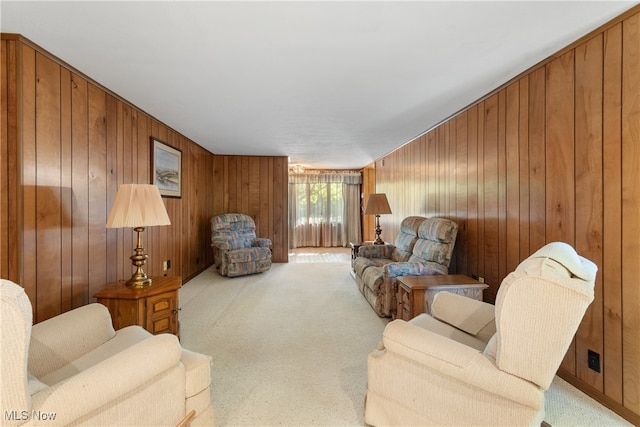 carpeted living room with wood walls