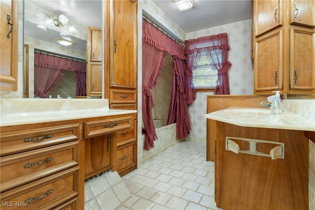 bathroom with tile patterned flooring, shower / tub combo with curtain, and vanity