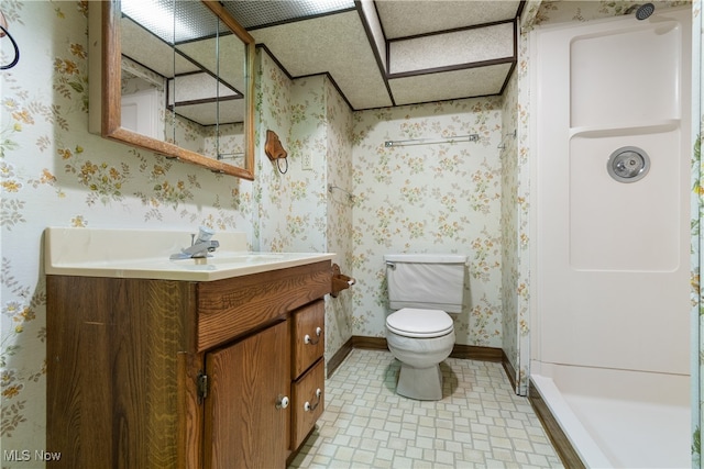 bathroom with vanity, toilet, and walk in shower