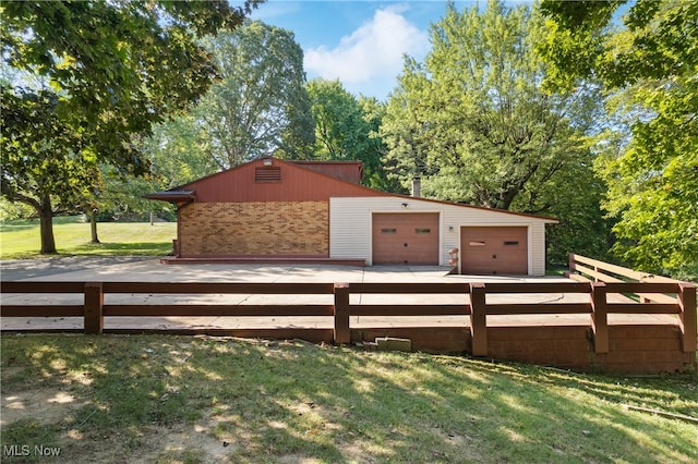 exterior space featuring a wooden deck and a garage