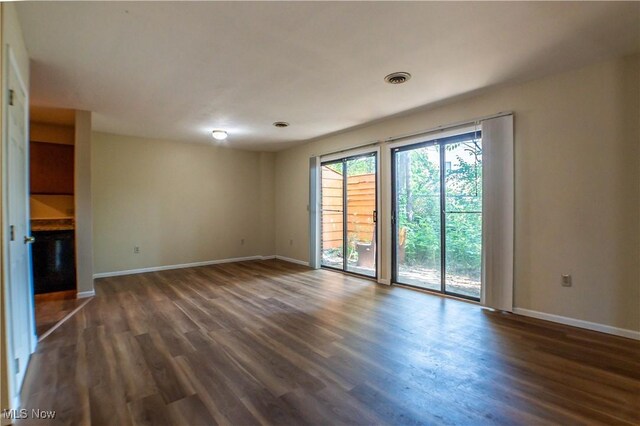 unfurnished living room with dark wood-type flooring