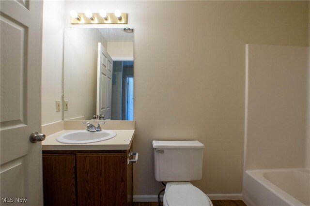 bathroom featuring toilet and vanity