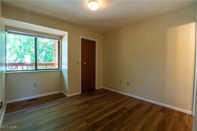 spare room featuring dark hardwood / wood-style floors