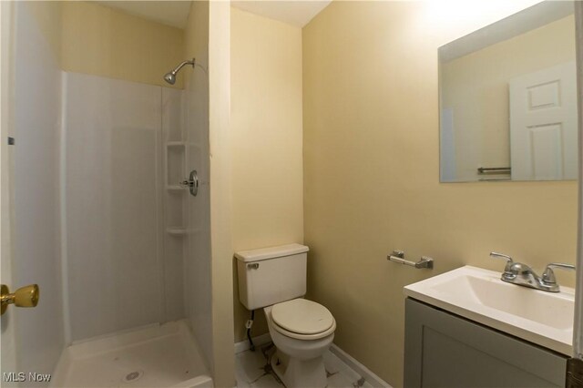 bathroom featuring vanity, toilet, and walk in shower