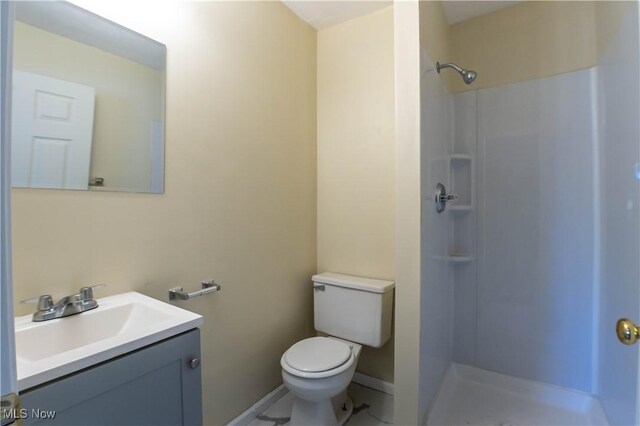 bathroom featuring vanity, toilet, and walk in shower