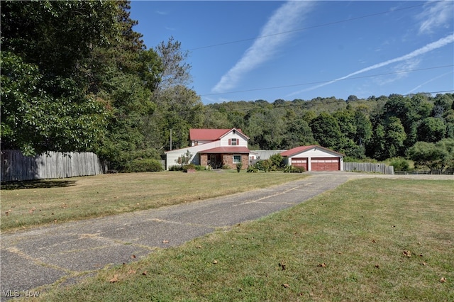 view of front of property featuring a garage and a front lawn