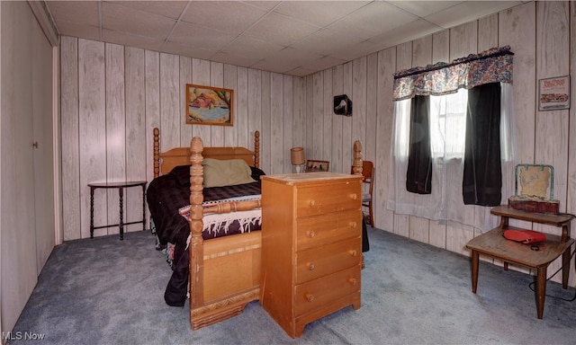 bedroom with carpet and wooden walls