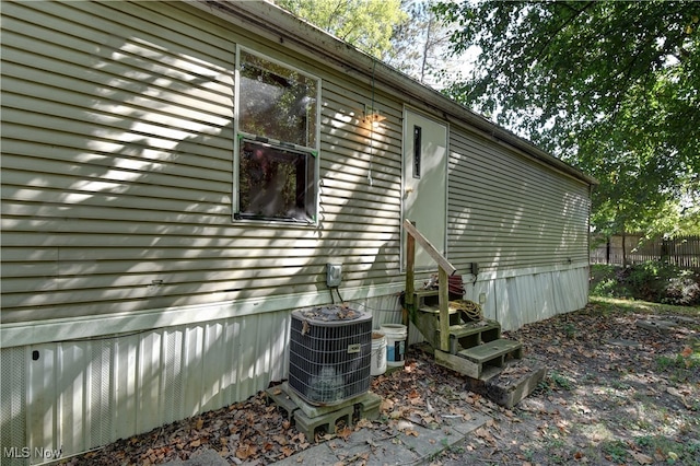 view of side of property featuring central air condition unit