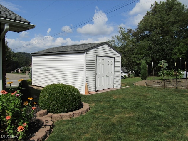 view of outbuilding featuring a lawn