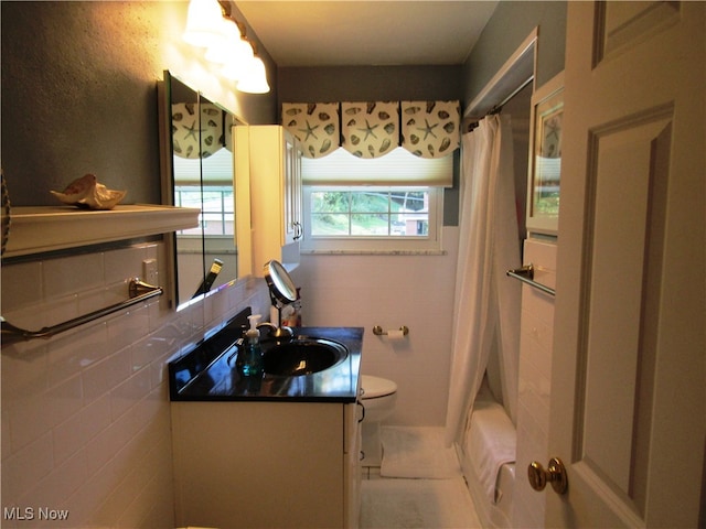 full bathroom with toilet, tile patterned floors, vanity, tile walls, and shower / bath combination with curtain