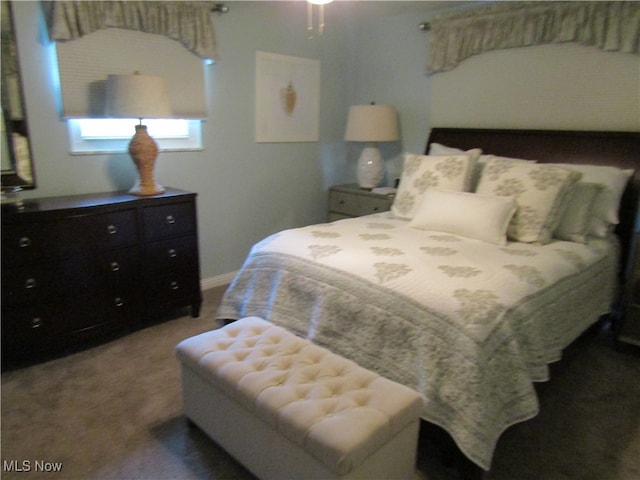 bedroom with dark colored carpet