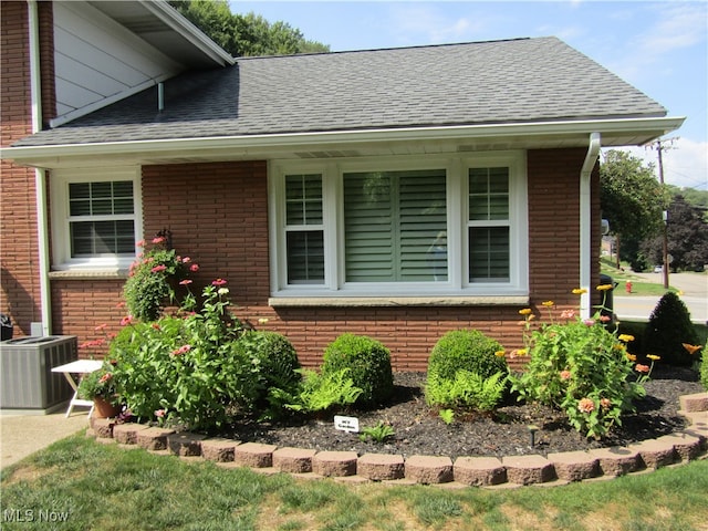 view of property exterior with central AC and covered porch