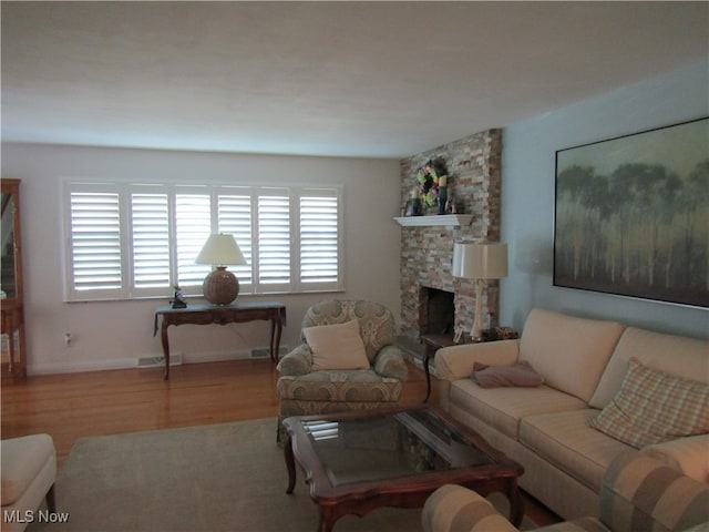 living room with a fireplace and hardwood / wood-style flooring