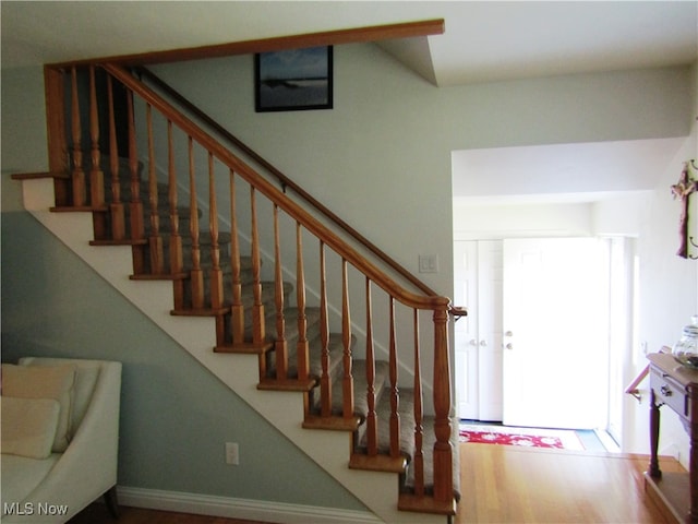 stairway with hardwood / wood-style flooring