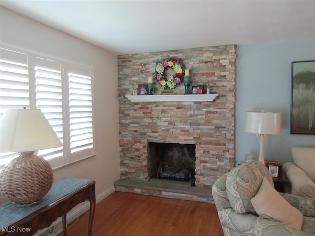 living room with plenty of natural light, hardwood / wood-style floors, and a fireplace