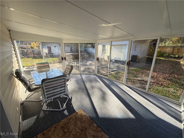 sunroom featuring lofted ceiling