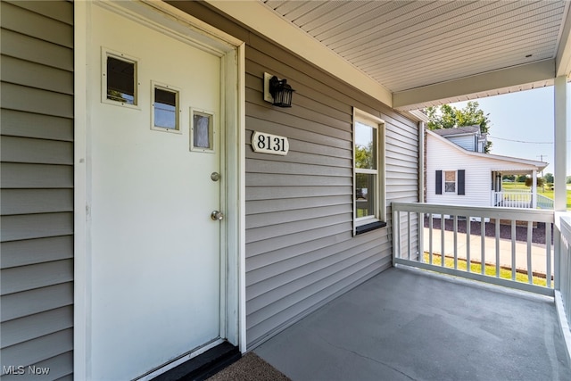 view of exterior entry featuring a porch