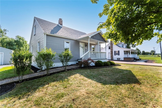 bungalow-style house with a front yard and covered porch