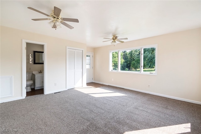 unfurnished bedroom featuring ceiling fan, carpet, and ensuite bath