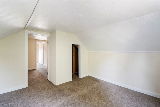 bonus room with lofted ceiling and carpet floors