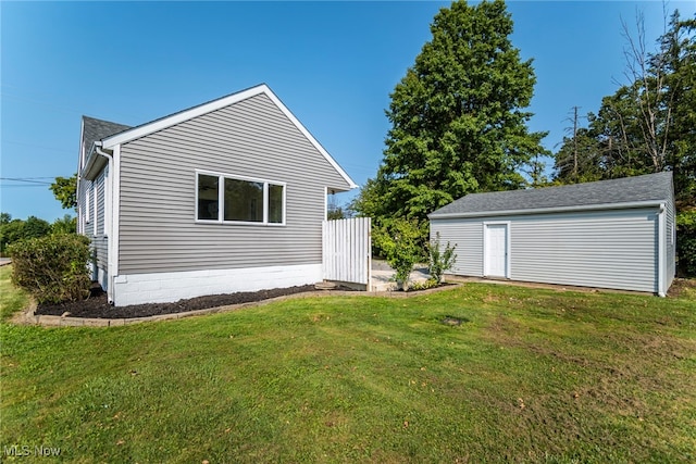 exterior space with an outbuilding and a lawn