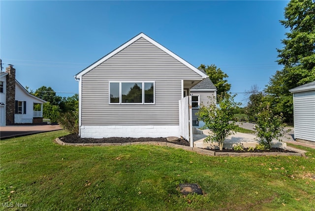 exterior space with a front lawn and a patio area