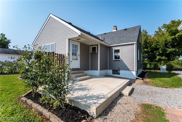 bungalow featuring a front yard and a patio