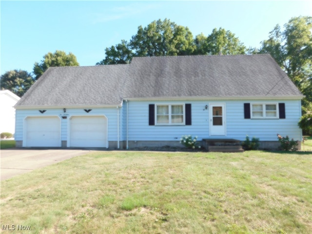 view of front facade with a garage and a front yard