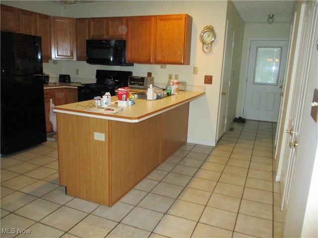 kitchen featuring black appliances, kitchen peninsula, and light tile patterned floors