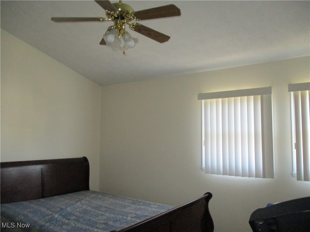 bedroom with multiple windows, a textured ceiling, and ceiling fan